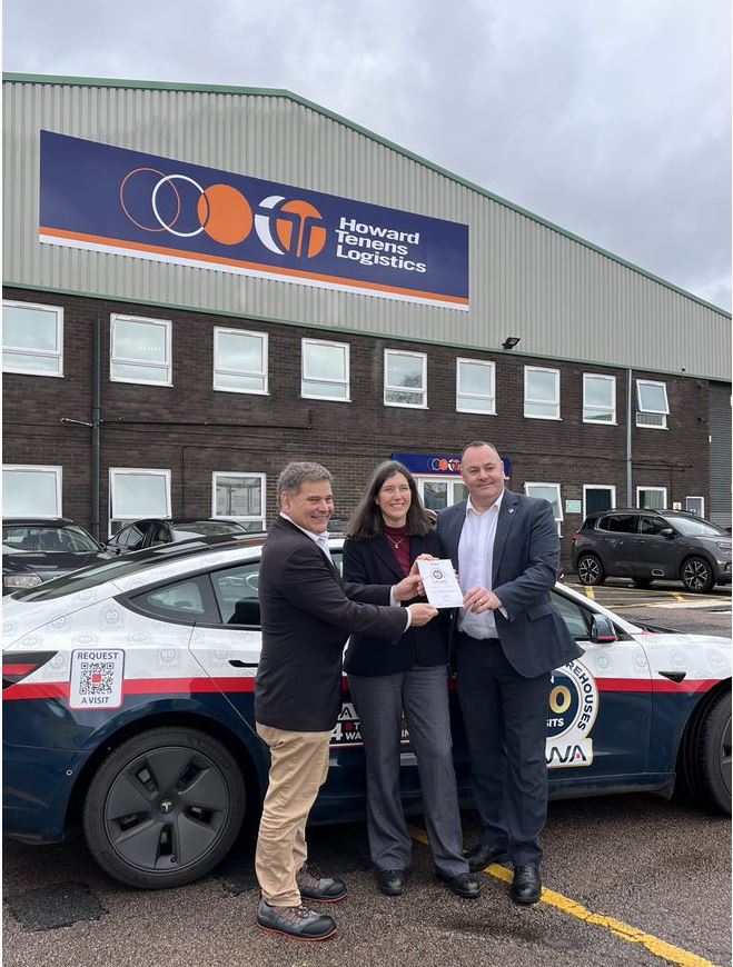 UKWA CEO Clare Bottle, Local MP Andrew Bridgen, and Howard Tenens Logistics Director Karl Hodgkinson pose for warehouse campaign visit next to campaign car
